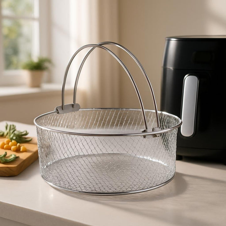 Lifestyle image: On a minimalist kitchen counter, the gleaming airfryer basket rests beside a sleek airfryer, surroun...