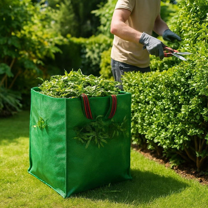 Lifestyle image: A green polypropylen affaldssæk filled with garden clippings, placed beside a gardener in gloves tri...