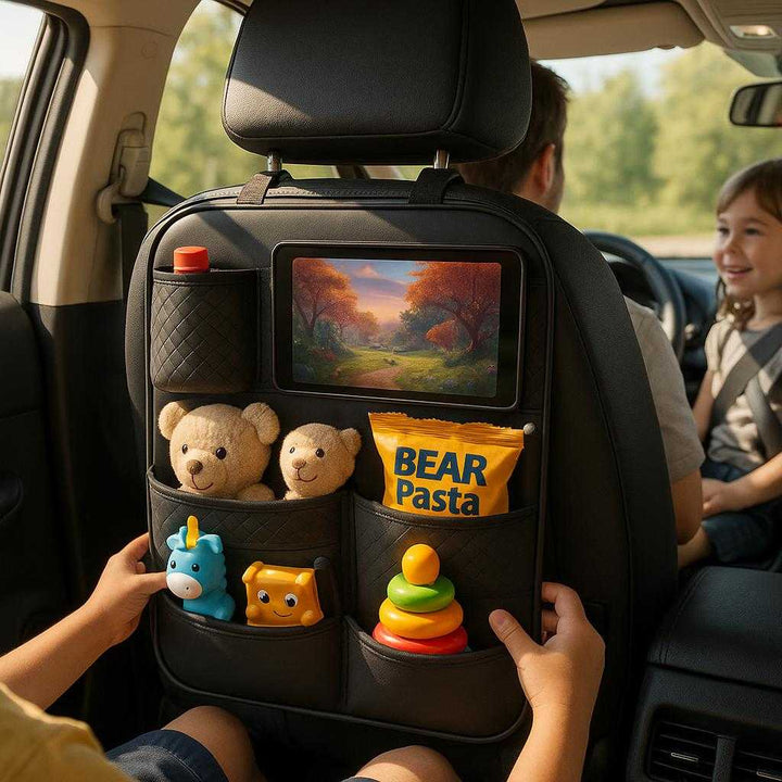 Bilsædeopbevaring i Sort Læderlook med Rektangulære Rum, Justerbare Stropper og Holdbar Design: A realistic car interior setting where the product is properly grounded on the back of a driver's seat, being actively used by a family during a road trip.