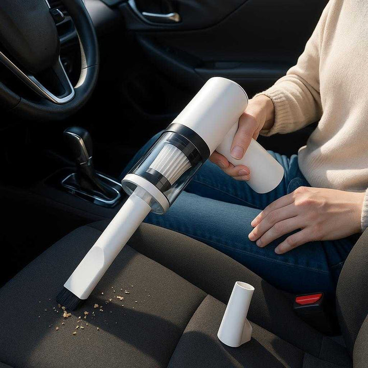 Bilstøvsuger Ledningsfri - Kompakt og Effektiv til Bilrengøring, Høj Kvalitet: A realistic car interior setting where the product is properly grounded on the passenger seat, being actively used by a person vacuuming crumbs from the driver's seat, with natural lighting casting realistic shadows and showing clear contact points where the product touches surfaces.