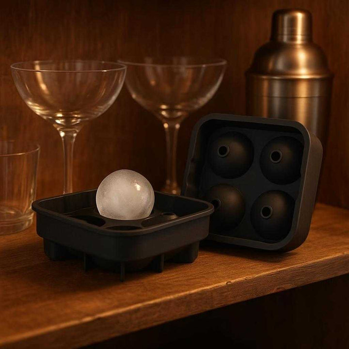 Isboldform i Silikone - Skab Perfekte Runde Isterninger til Whisky, Cocktails og Iskaffe: A different realistic home bar setting where the silicone ice mold is securely positioned on a rustic wooden shelf, naturally placed next to a set of cocktail glasses and a shaker.