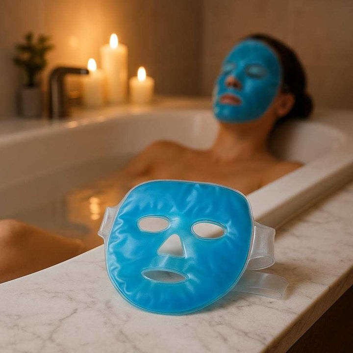 Kølende Gel Ansigtsmaske - Genanvendelig og Beroligende Maske til Afslapning & Hudpleje: A serene bathroom setting where the Kølende Gel Ansigtsmaske is securely positioned on a marble countertop, being used differently by a person lying back in a luxurious bathtub with candles and soft ambient lighting, with proper physics, shadows, and realistic integration into the spa-like environment.