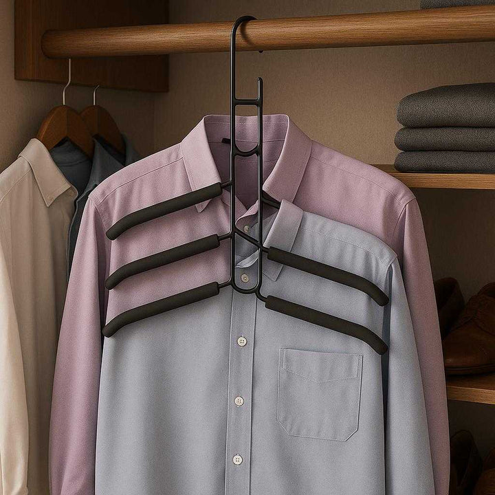 Magisk bøjle i sort - metal, plastik, gummi - Pladsbesparende og organiseret: A realistic walk-in closet where the magic hanger in black is properly grounded on a wooden closet rod, being actively used to hold multiple shirts in a neatly organized fashion, showcasing its space-saving capabilities.