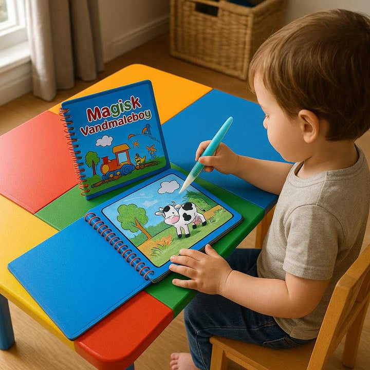 Magisk Vandmalebog – Genanvendelig og Farverig Leg for Børn: A realistic playroom setting where the Magisk Vandmalebog is properly grounded on a colorful children's table, being actively used by a small child with a water-filled brush.