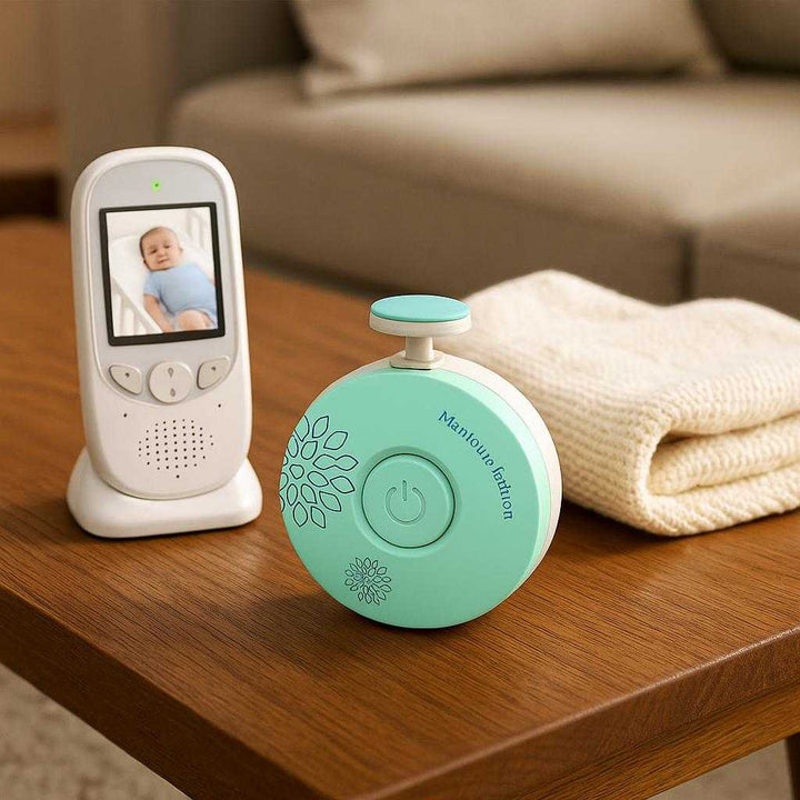 Negleklipper til Baby med LED Lys - Ergonomisk og Sikker Elektrisk Design i Mintgrøn: A different realistic living room setting where the product is securely positioned on a coffee table, placed naturally next to a baby monitor and a soft baby blanket, in a believable way, with proper physics, shadows, and realistic integration into the environment.