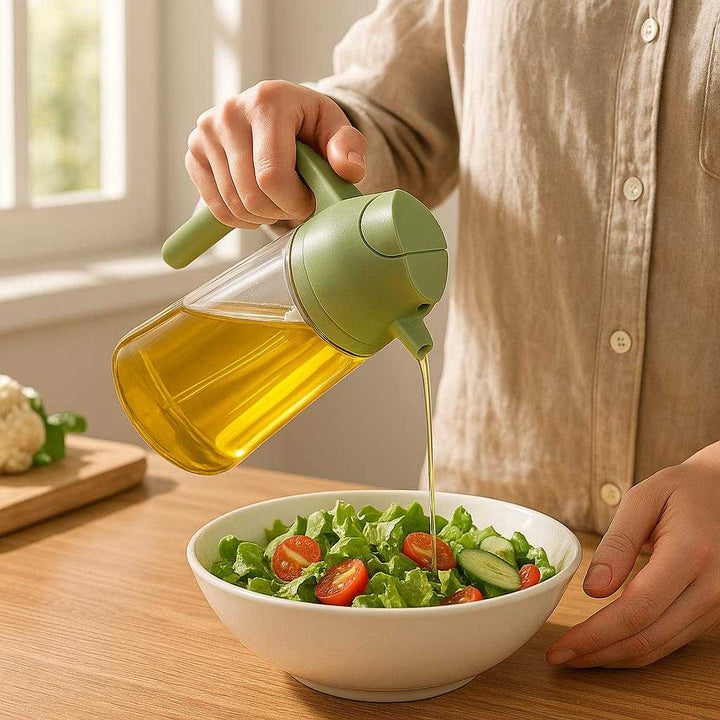Olieflaske med Hældetud og Pensel - Praktisk og Multifunktionel i Keramik, Tilgængelig i 4 Farver: A realistic kitchen setting where the product is properly grounded on a wooden countertop, being actively used by a person who is drizzling oil onto a fresh salad, with natural lighting streaming through a window casting realistic shadows and showing clear contact points where the product touches the surface.