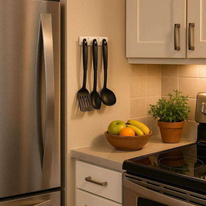 Ophængsbeslag i moderne design - Pladsbesparende og let at installere - Tilgængelig i Sort og Hvid: A stylish kitchen environment, with the wall-mounted bracket in white neatly installed next to a refrigerator, used to hold kitchen utensils like spatulas and ladles.