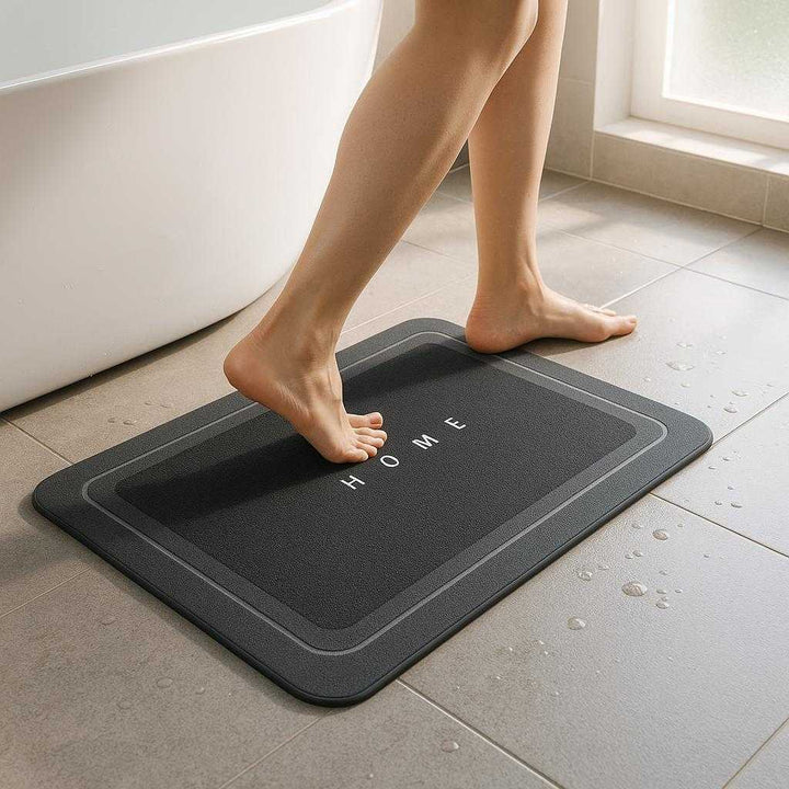 Sikkerhedsfunktioner Skridsikker Bademåtte i Mørkegrå - Avanceret Design til Badeværelset: A realistic modern bathroom setting where the dark gray non-slip bath mat is properly grounded on a tiled floor next to a sleek, white bathtub.
