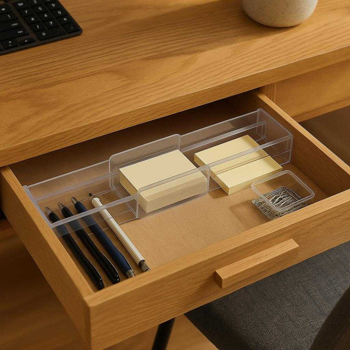 Skuffeopdeler i justerbar plast tilbehør – Organisér nemt og effektivt i hjemmet: A different realistic office desk setting where the product is securely positioned inside a desk drawer, organizing stationary items like pens, notepads, and paper clips in a neat and orderly fashion.
