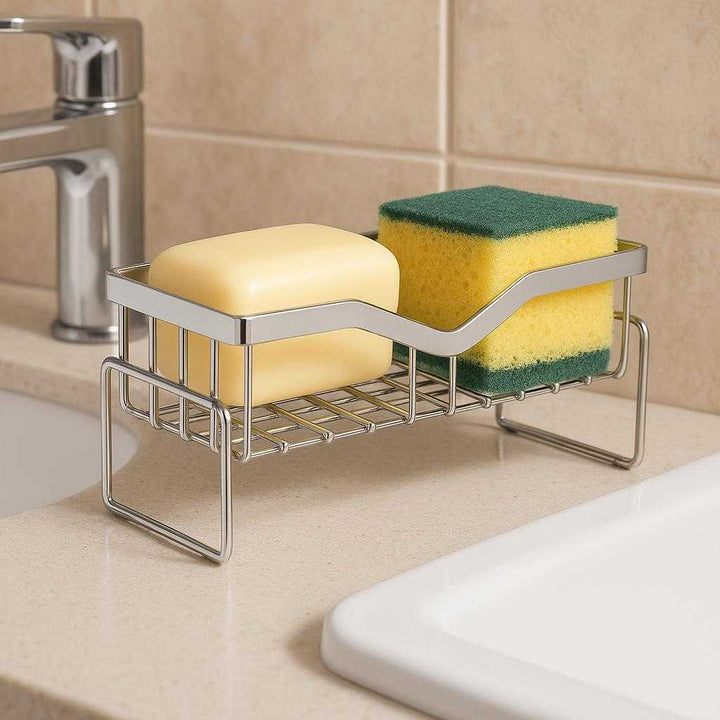 Svampeholder i Rustfrit Stål med Magnetisk Funktion og Effektiv Dræning til Køkkenvask: A different realistic bathroom setting where the sponge holder is securely positioned on a flat countertop near the sink, naturally holding a soap bar and a small scrubber.