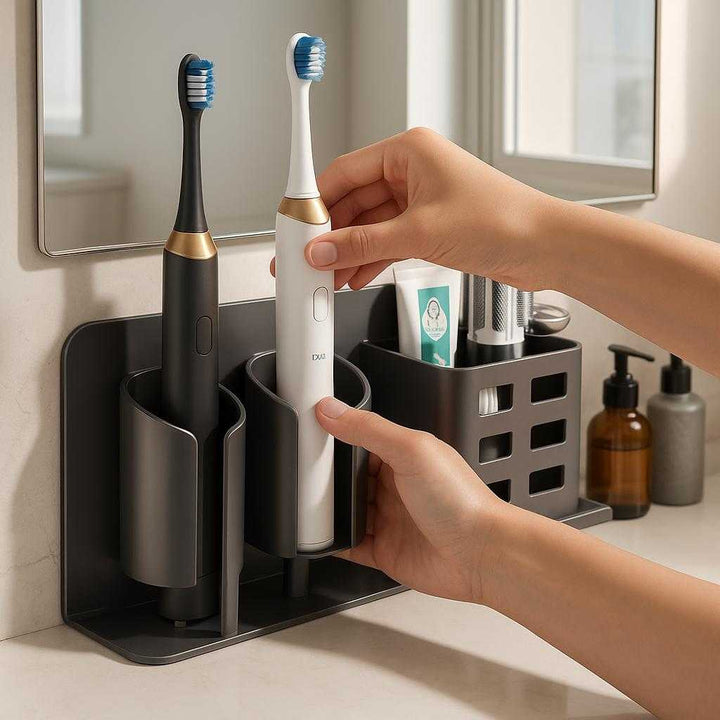 Tandbørsteholder med indbygget dispenser og opbevaring - Moderne design i grå og hvid: A realistic modern bathroom setting where the toothbrush holder with built-in dispenser and storage is properly grounded on a smooth countertop, being actively used by a person's hands placing a toothbrush into the holder.
