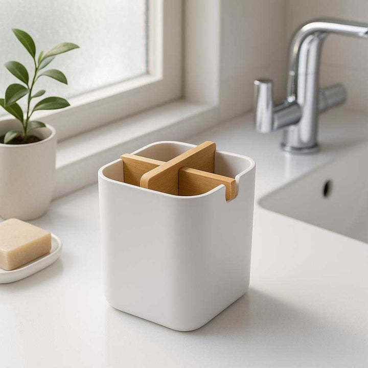 Tandbørsteholder til væg med låg - Moderne og hygiejnisk opbevaring til badeværelset - Tilgængelig i Sort og Hvid: A realistic modern bathroom setting where the toothbrush holder is properly grounded on a sleek, white bathroom countertop, being naturally placed next to a minimalist sink with chrome fixtures.