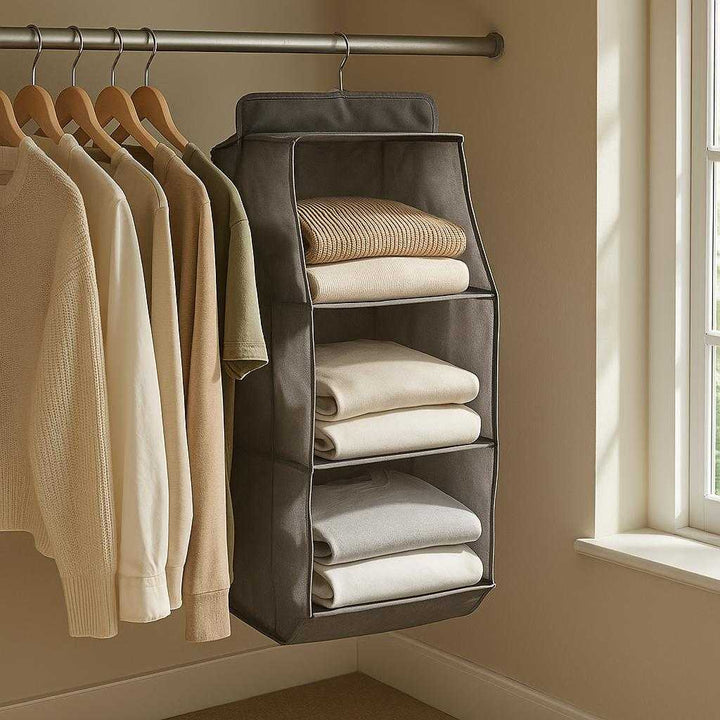 Taskeorganiser til Tøjskab i Gråt Stof med Gennemsigtige Paneler - Professionel og Høj Kvalitet: A realistic bedroom closet setting where the gray fabric wardrobe organizer is properly grounded on a hanging rail, naturally placed among other clothes.