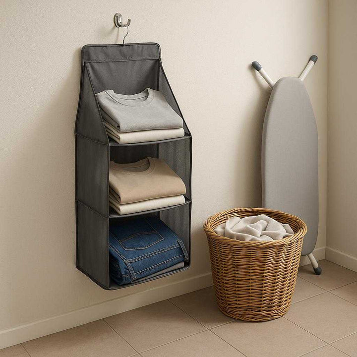 Taskeorganiser til Tøjskab i Gråt Stof med Gennemsigtige Paneler - Professionel og Høj Kvalitet: A different realistic laundry room where the gray wardrobe organizer is securely positioned on a sturdy hook mounted on the wall.