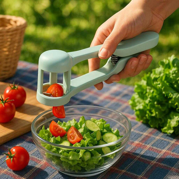 Tomatskærer tilbehør – Præcisionspresser i moderne design: A different realistic picnic setting in a garden where the product is securely positioned on a plaid picnic blanket, naturally placed next to a variety of fresh produce including tomatoes and lettuce.
