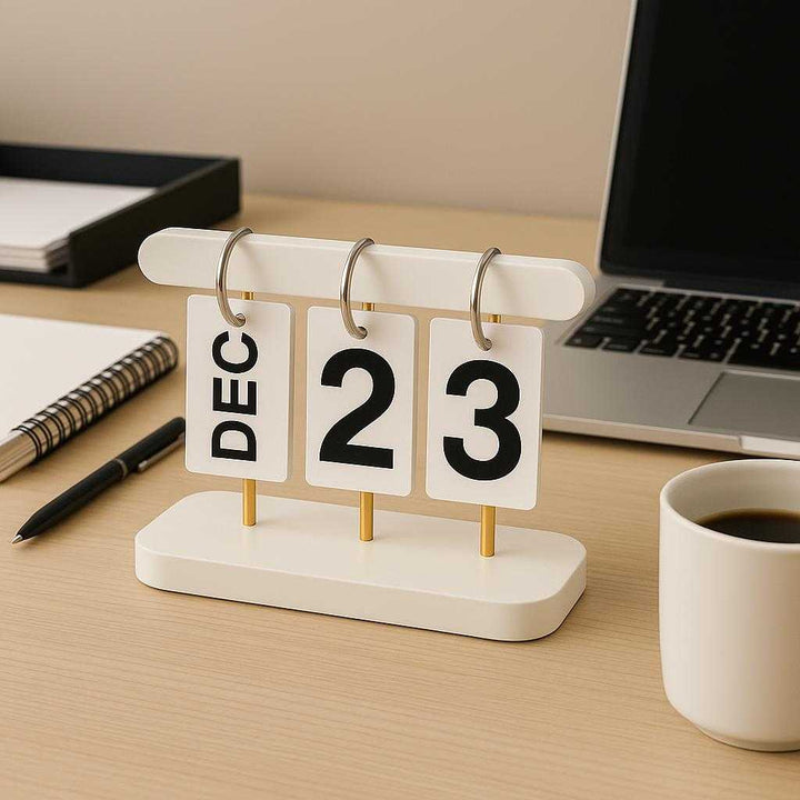 Vendekalender i Hvid og Sort med Minimalistisk Design – Professionel og Tidløs Kalenderløsning i Metal og Plastik. The minimalist white and black calendar sits elegantly on an office desk next to a laptop and coffee mug, surrounded by neat organization, emphasizing productivity and style.